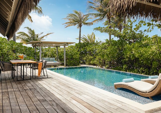 Outdoor pool with loungers and table