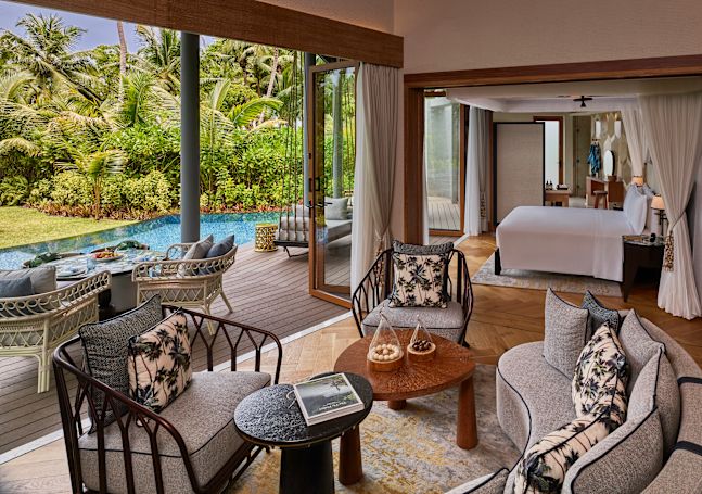 Guestroom lounge area with sofa and chairs
