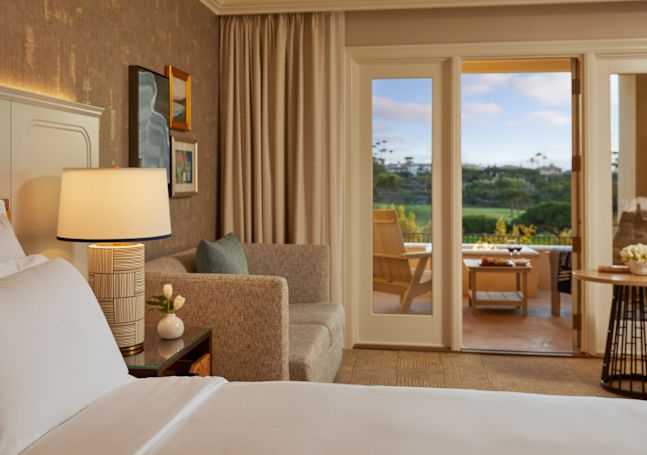 bedroom with sofa and patio view