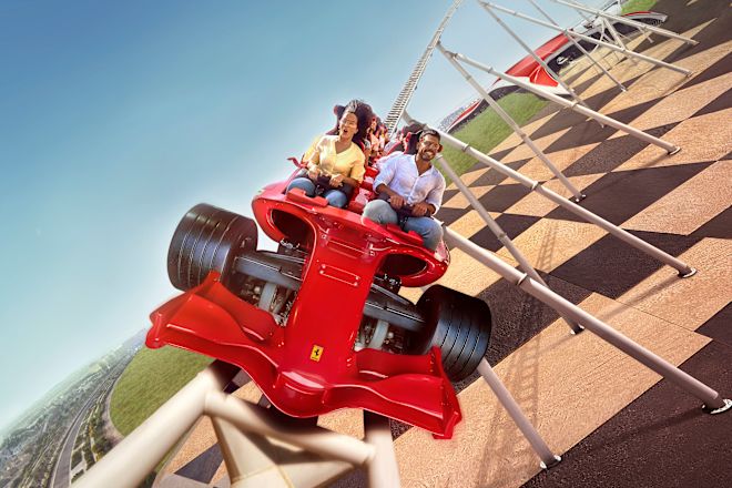 a group of people riding a roller coaster at Ferrari World