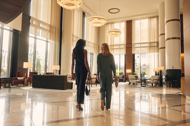 Two women walking through spacious lobby area