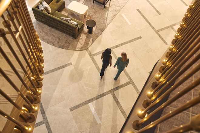 Two women walking through spacious lobby area