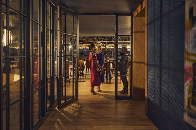 Two women standing at restaurant entrance