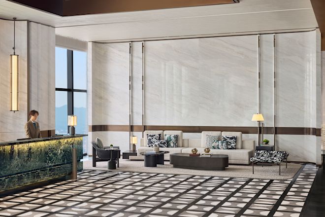 Staff Member at the Front Desk and View of Sitting Area in Lobby