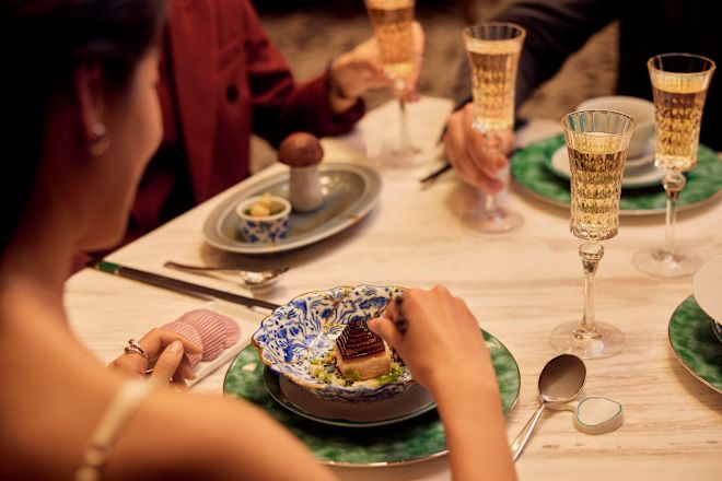 砂漠を食べるテーブルに座る女性の肩越しのショット