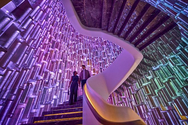 Man and woman walking down spiral staircase