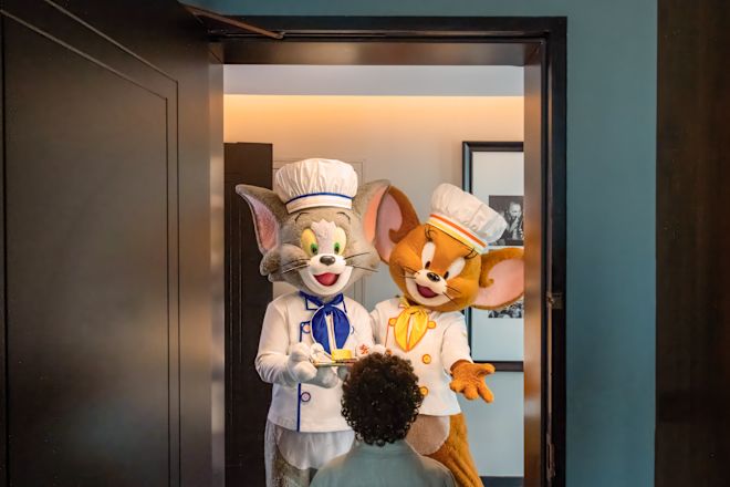 Tom and Jerry dressed as chefs at guest room door