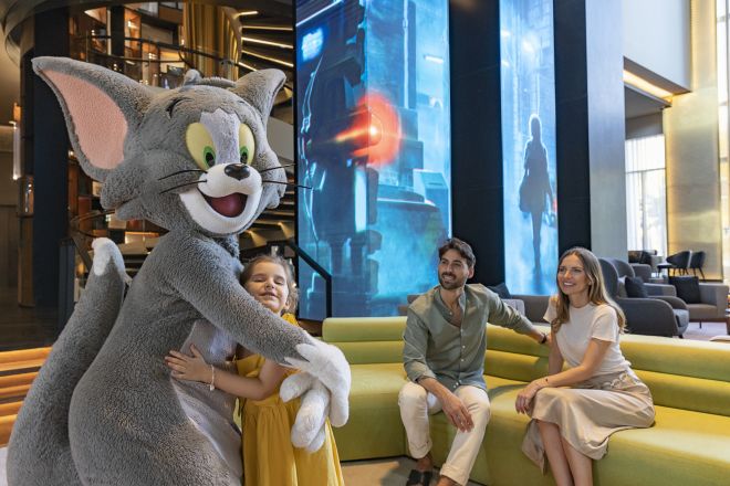Person in Tom costume with family