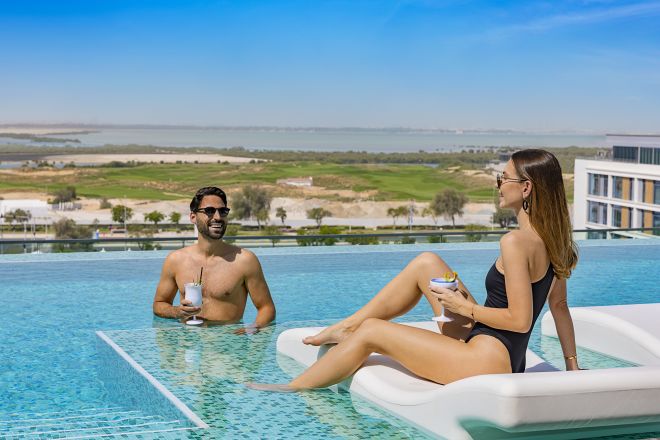 Woman and man at pool with drinks