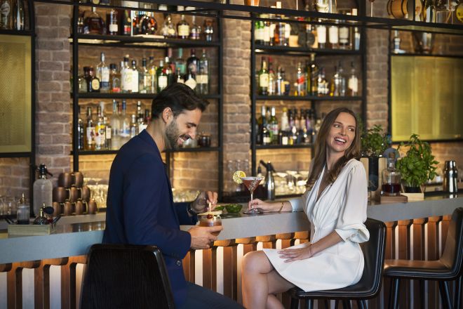Man and woman sitting at bar
