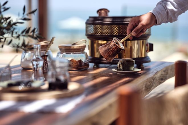 Man Serving Coffee at Platia  A La Carte Restaurant