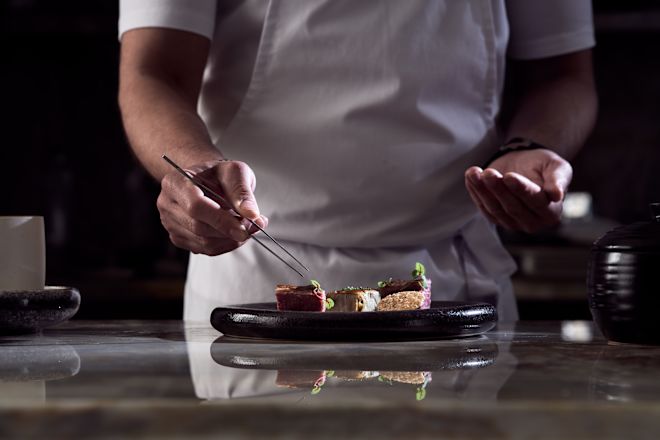 Chef Preparing Food at Cretamos Restaurant