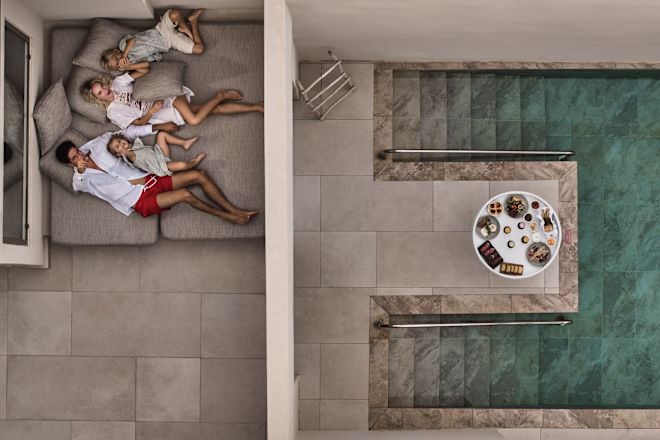 a Family on a Bed in a Suite with Floating Breakfast in the Room