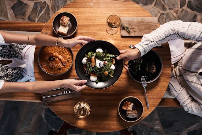 Couple Holding a Plate of Food while Dining at Platia