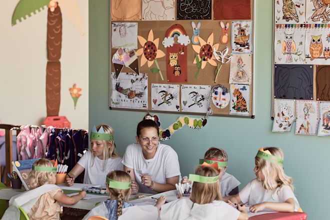 Woman and  with Six Girls during a Coloring Activity