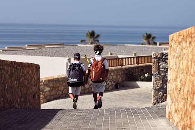 Two Boys Walking with Bag Packs toward the Beach