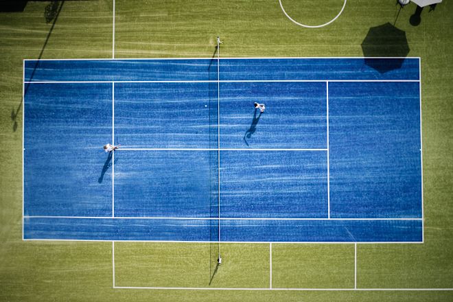 People Playing Tennis on Outdoor Tennis Court
