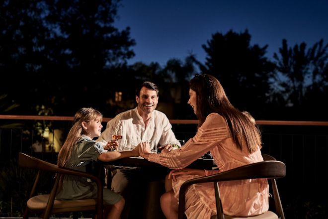 Family Having Dinner in a Terrace at a Restaurant