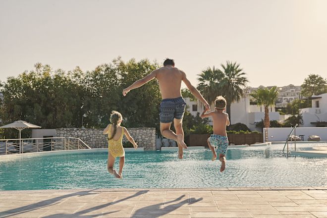 Man with Kids Jumping in the Pool