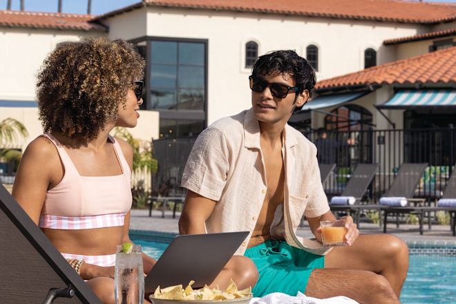 Couple Enjoying Drinks and Snacks by the Pool Area