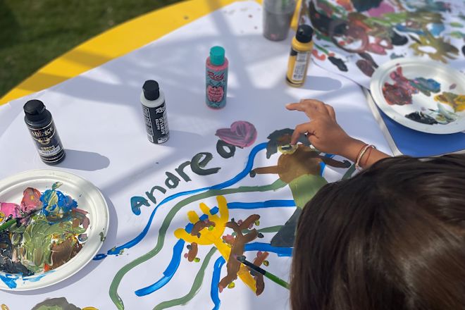 Kid doing painting outside