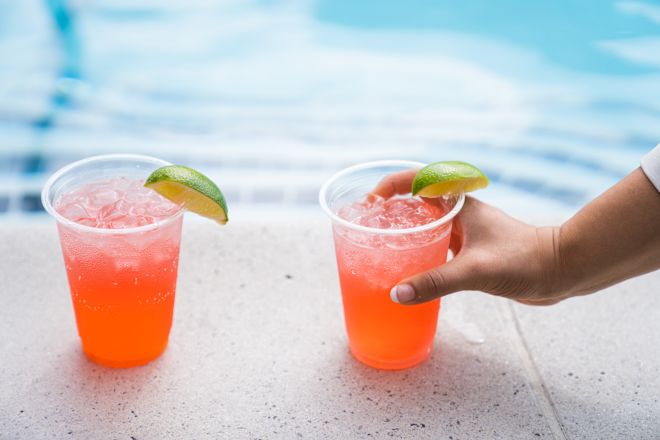 Dua koktail berada di tepi kolam renang
