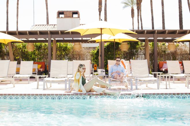 Man and woman relaxing by pool