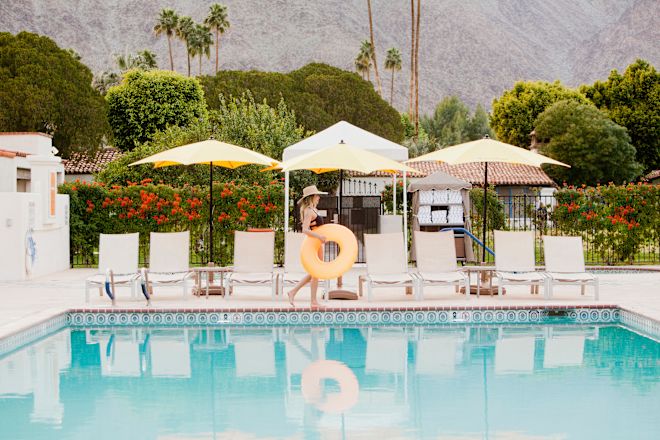 Woman walking past pool with rubber ring