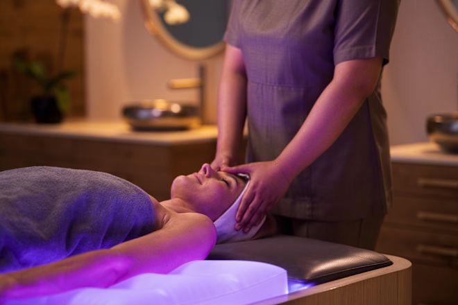 「エフォリア・スパ」のトリートメントルームでフェイシャルを楽しむ女性