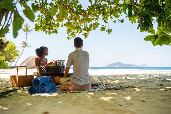 Couple Enjoying a Picnic at the Beach