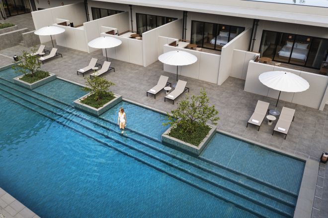 Outdoor pool with model and loungers