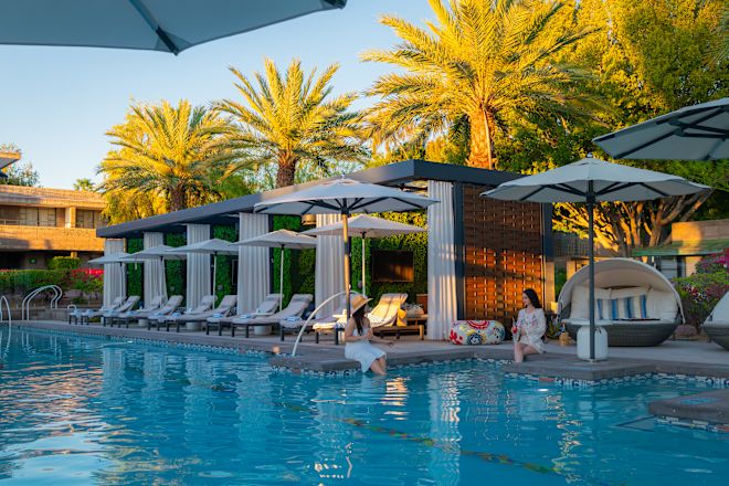 Two Women in Outdoor Pool Area at Sunset