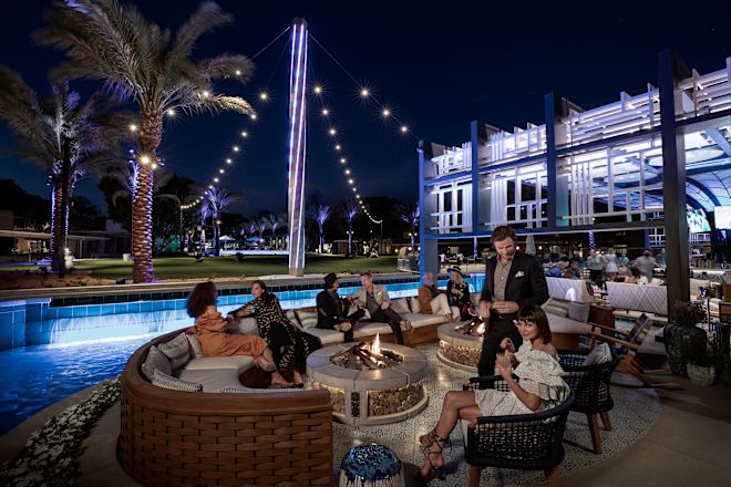 People sitting outside, with pool