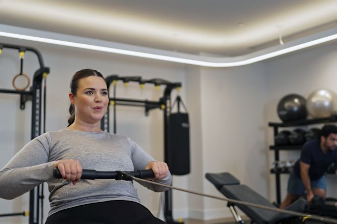 Woman Getting a Rowing Workout in the Fitness Center