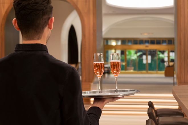 Lobby bar with water holding tray with wine glasses