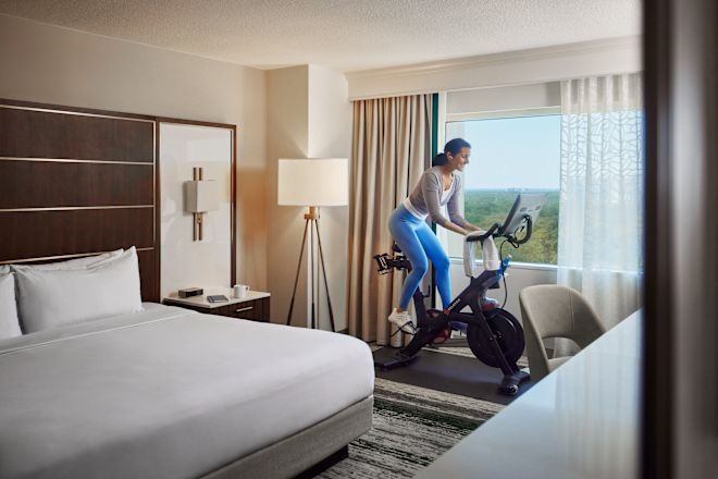 Woman working out on an exercise bike in her room