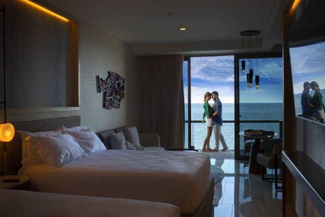 Couple on bedroom balcony with room in foreground