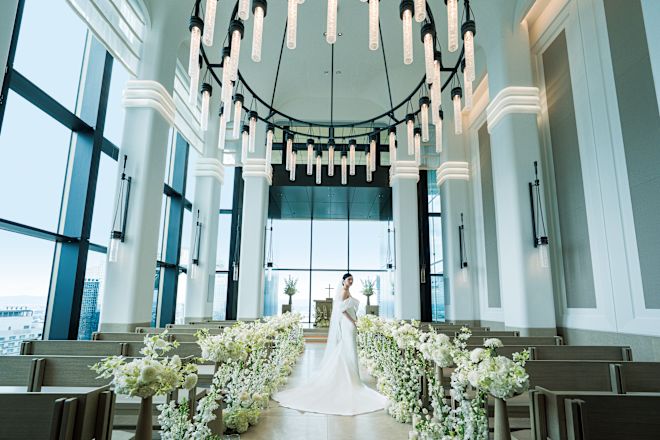 Bride standing in the aisle of the chapel.