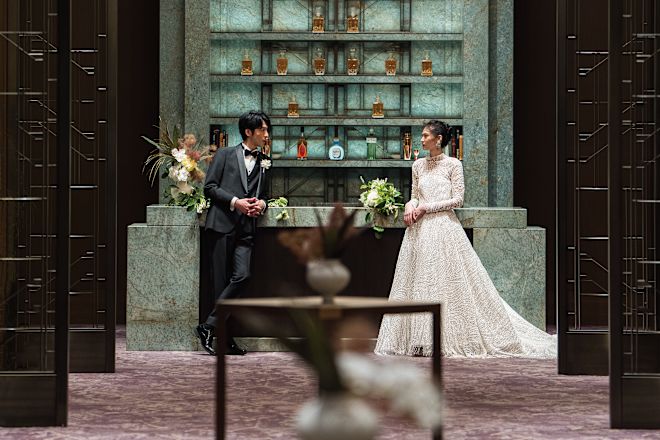 Bride and groom standing in front of the bar.