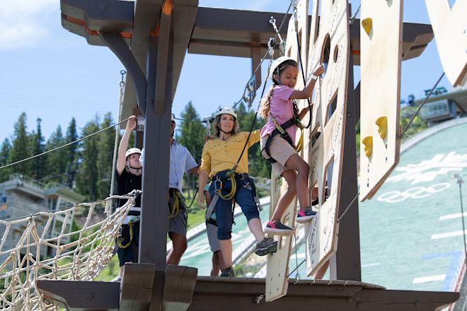 A family experiencing the wall and rock climbing activity.