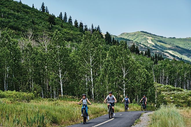  A Group of People Riding Bicycles Outdoors 