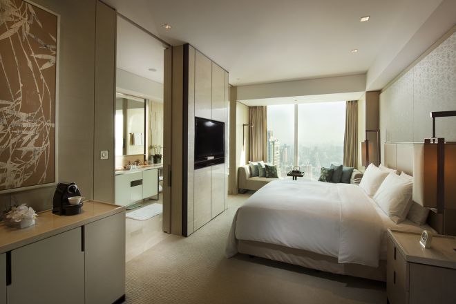 King-Sized Bed and Large Window in Deluxe Room