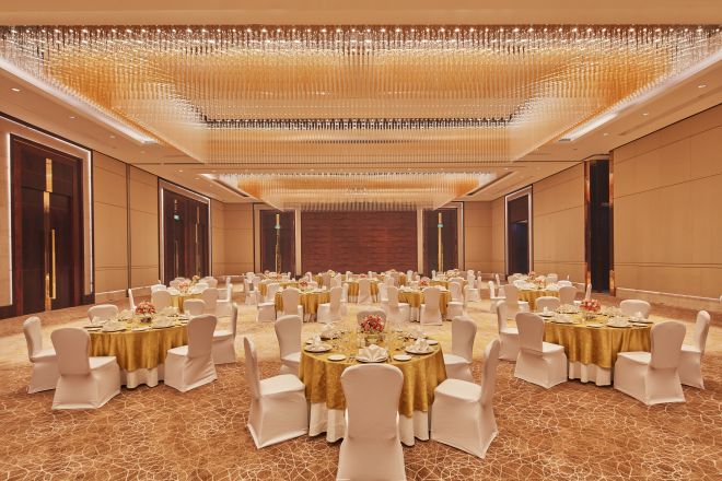 Spacious Ballroom Area with Round Tables and Chairs
