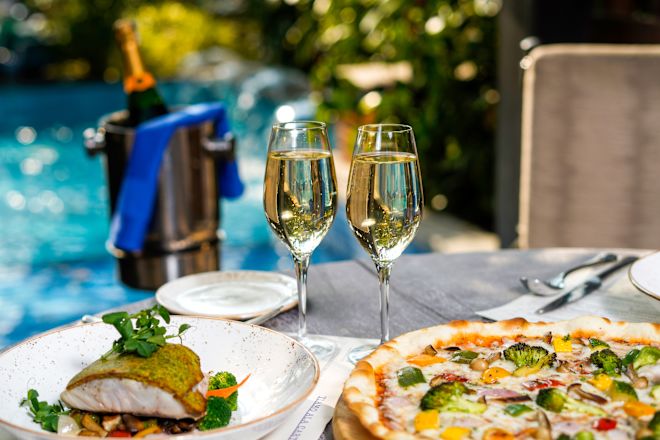 Champagne and two meals on plates outside