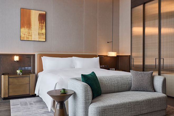 Large Bed and Sofa in a Guest Room