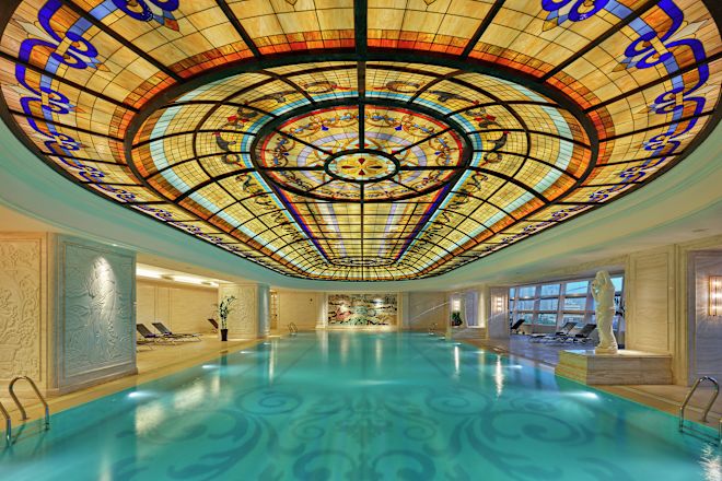 Indoor pool with ornate ceiling