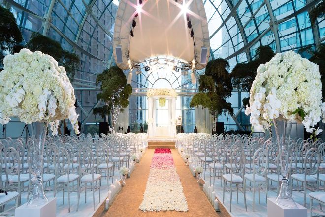 atrium event venue setup for wedding with rows of chairs