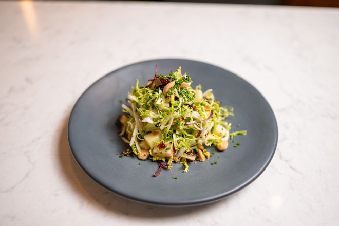a Plate with Salad at ATRIO Wine Bar and Restaurant