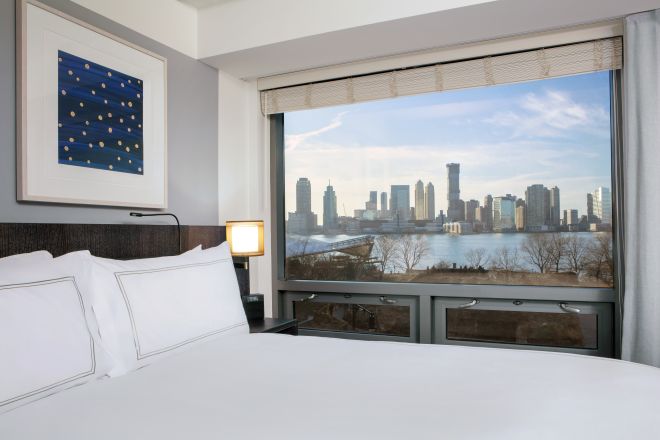Bed in room with view of skyline