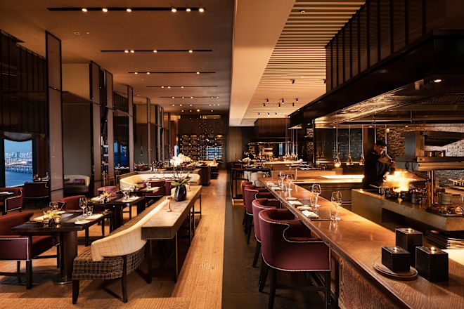 Interior of the 37 Bar and Grill. The space is complete with dark wood, modern finishes, and plush seating.